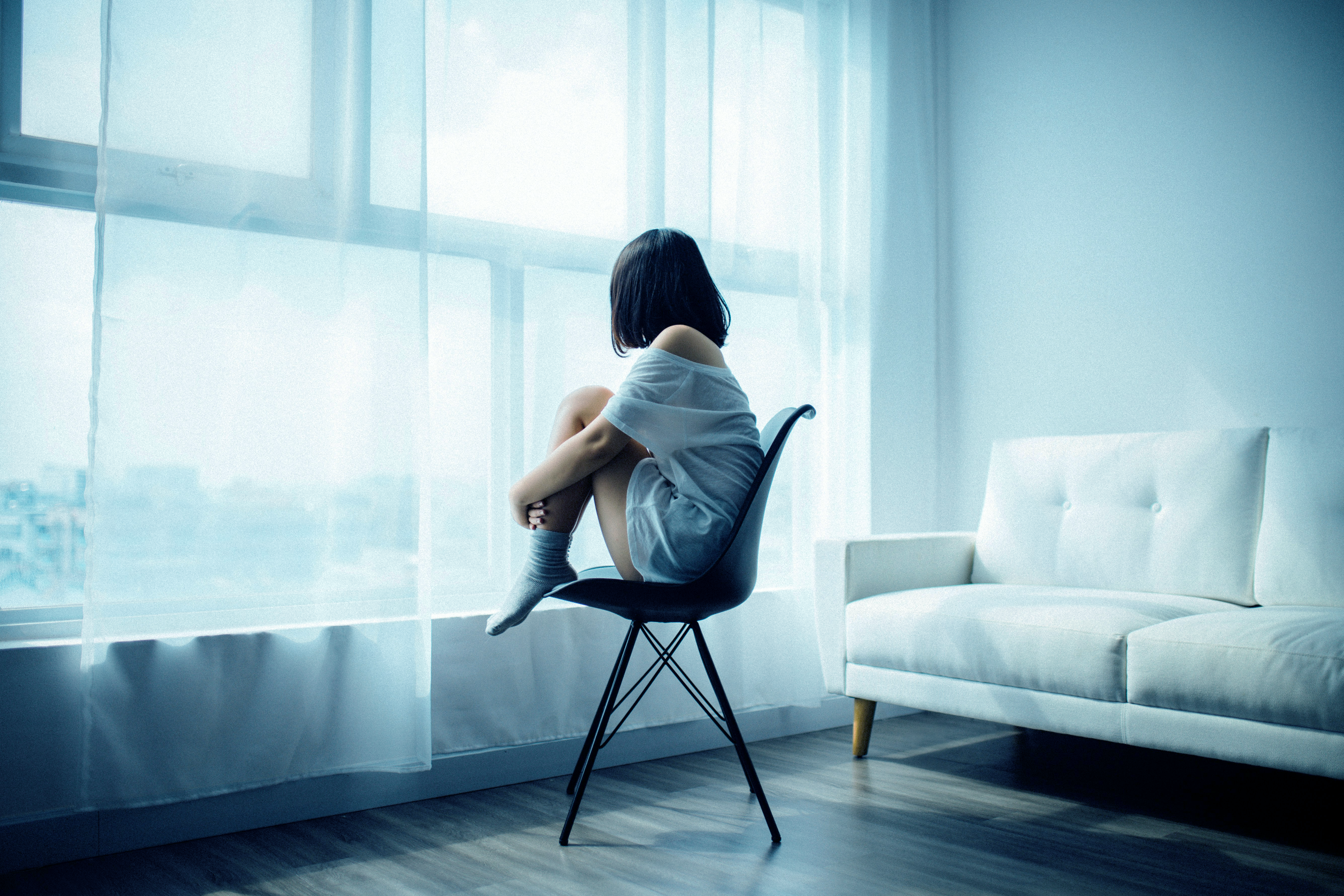 Woman sitting in a chair alone in the room